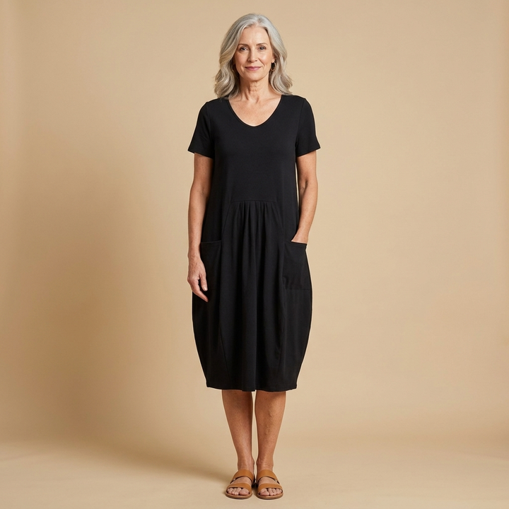 Oriane dress in black, full length on a warm studio backdrop